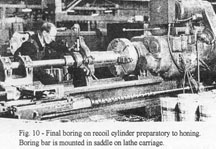 Final boring on recoil cylinder preparatory to honing. Boring bar is mounted in saddle on lathe carriage