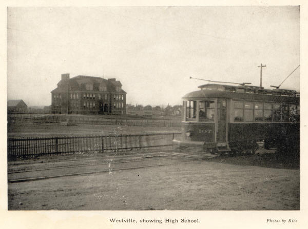 Tram car passing high school